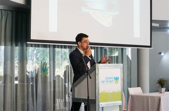 A picture of a mascot looking like the CEO speaking at a conference